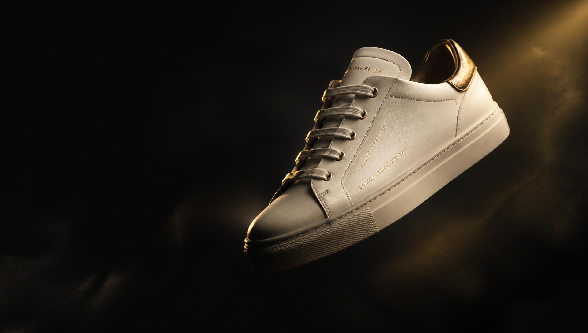 Premium leather sneaker lit by golden studio light